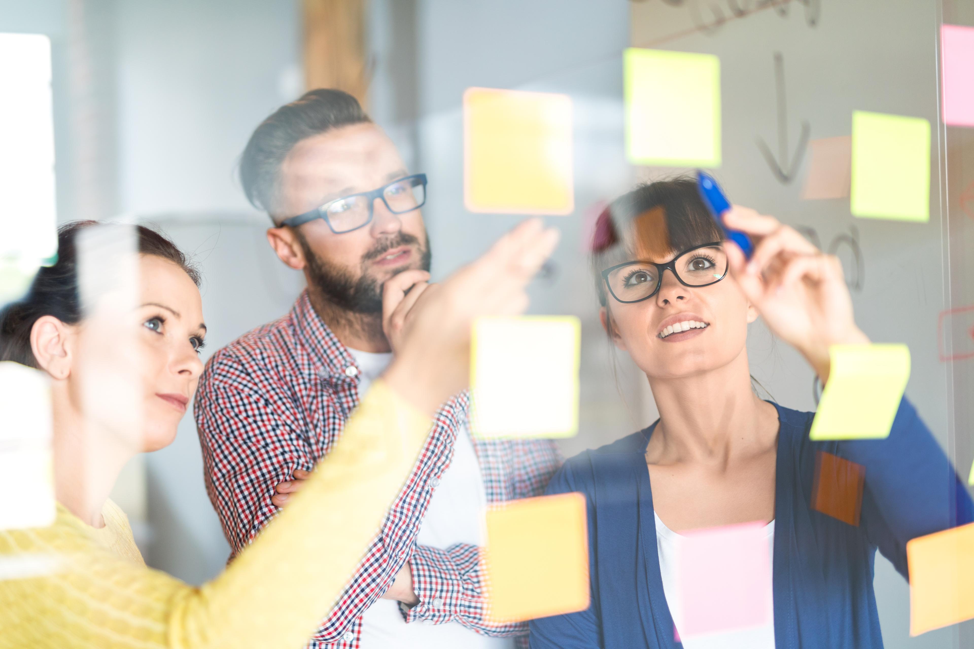 people analyzing data on a whiteboard